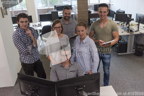Image of group of young startup business people standing as team