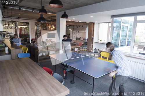 Image of playing ping pong tennis at creative office space