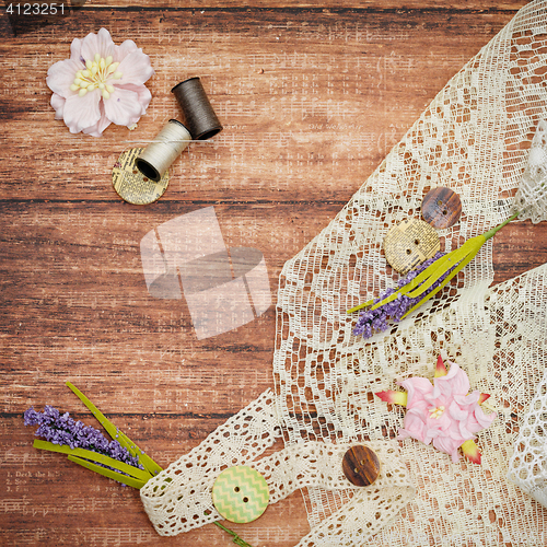 Image of Lace and thread on wooden background