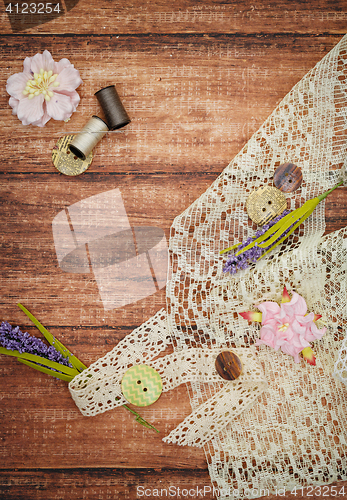 Image of Lace and thread on wooden background