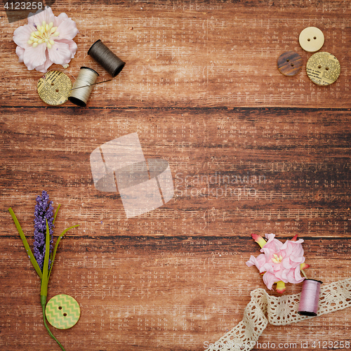 Image of Lace and thread on wooden background