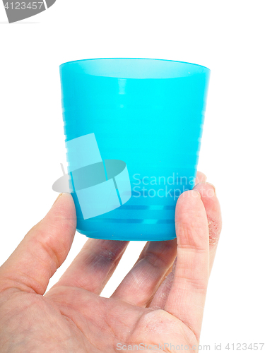 Image of Empty blue plastic glass, held in a male persons hand