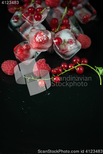 Image of Frozen berries on wooden table