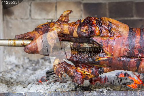 Image of Roasting suckling pig on the broach