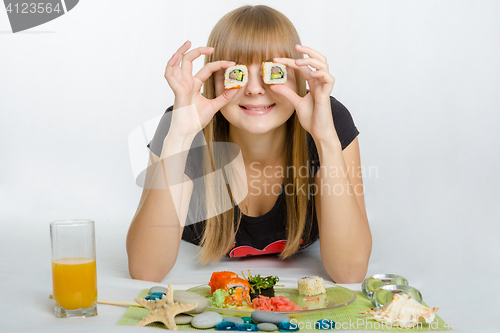 Image of Young girl put roll your eyes and with a smile looks in the frame