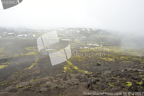 Image of Lava terrain in Iceland. Mountains in the background.