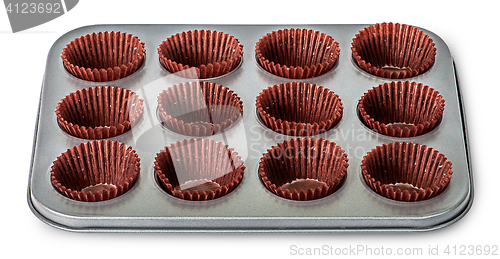 Image of In front cupcake and muffin pan with paper cups