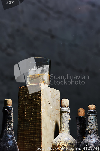 Image of Glass of whiskey with ice on old wooden bar