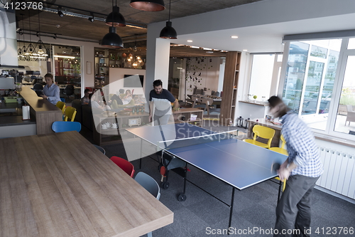 Image of playing ping pong tennis at creative office space