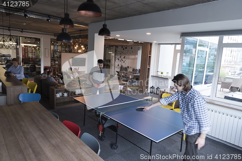 Image of playing ping pong tennis at creative office space