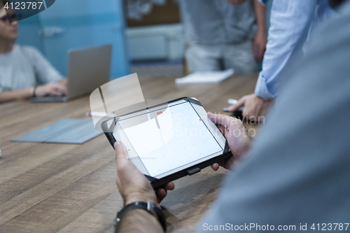 Image of close up of businessman on meeting using tablet