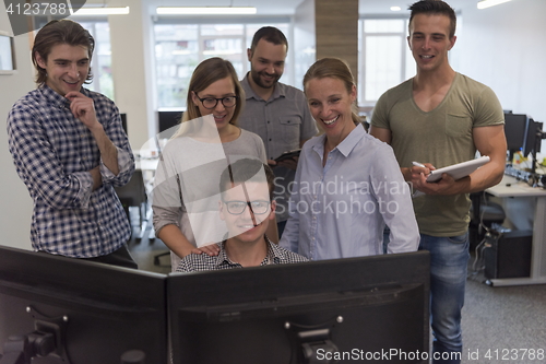 Image of group of young startup business people standing as team