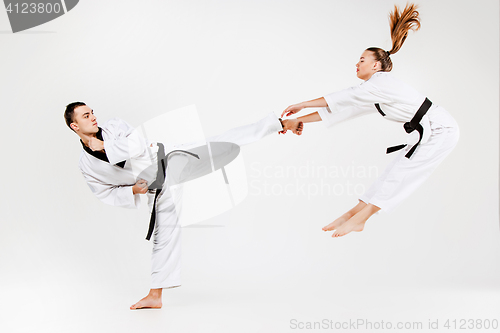 Image of The karate girl and boy with black belts