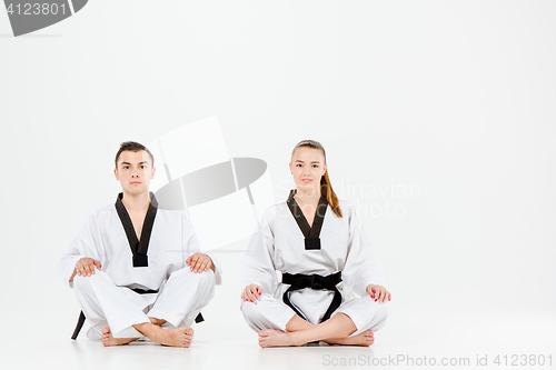 Image of The karate girl and boy with black belts