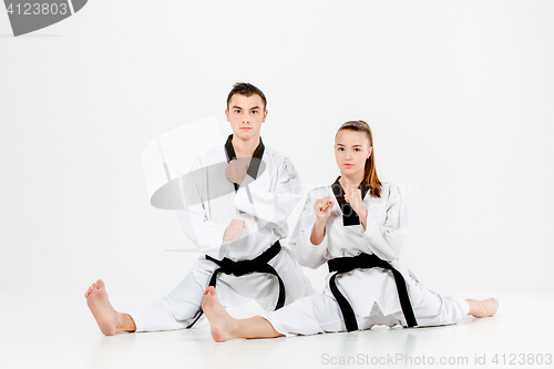 Image of The karate girl and boy with black belts