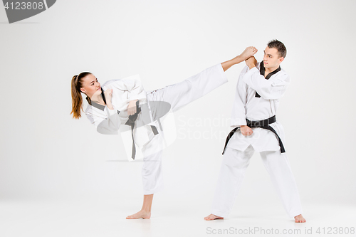 Image of The karate girl and boy with black belts