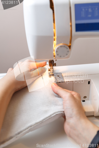 Image of Seamstress working at sewing machine