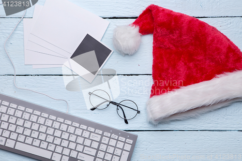 Image of Santa hat, glasses, blank photo