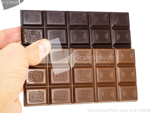 Image of Person holding two whole bars of light and drak chocolate isolat