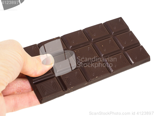 Image of Person holding a whole bar of dark chocolate isolated towards wh