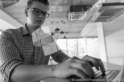 Image of young  man working on laptop