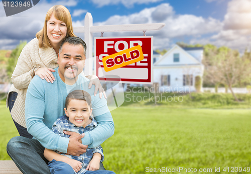 Image of Mixed Race Family In Front of House and Sold For Sale Real Estat