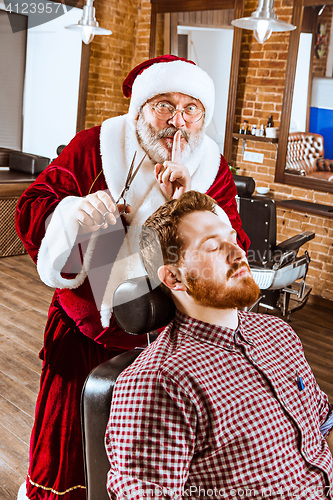 Image of Santa claus as master at barber shop