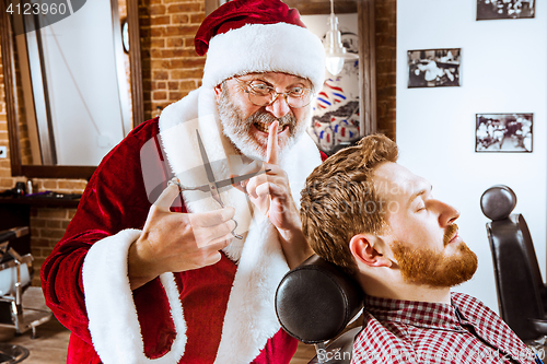 Image of Santa claus as master at barber shop