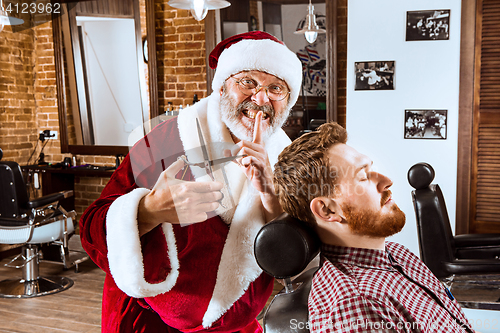 Image of Santa claus as master at barber shop