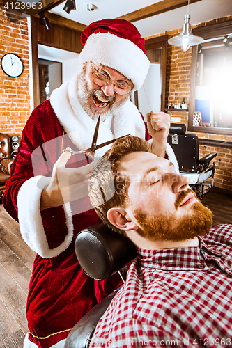 Image of Santa claus as master at barber shop