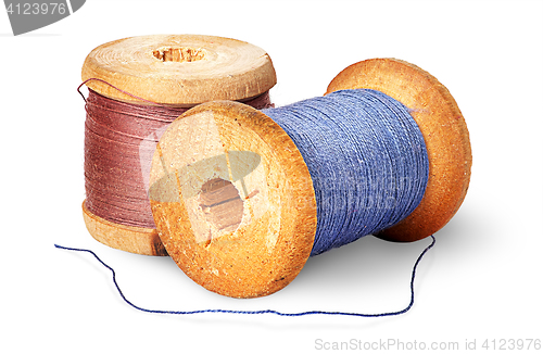 Image of Two different colored thread on wooden spools