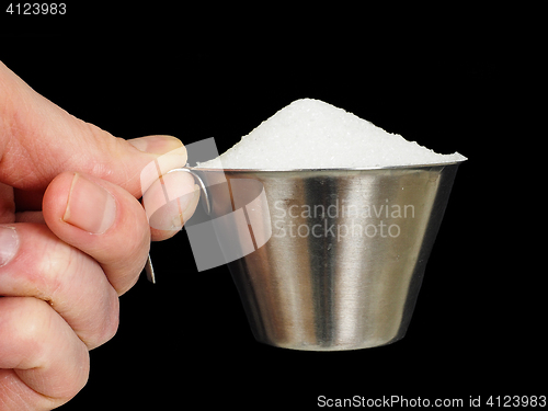 Image of Person holding a measuring cup of one deciliter filled up with w