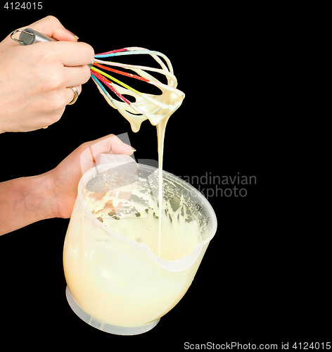 Image of Female person making Gogl-Mogl, with hand whisker in plastic bow