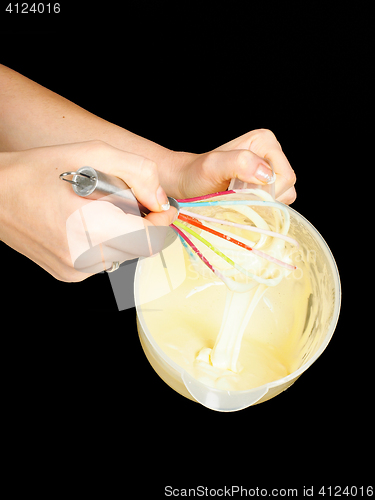 Image of Female person making Gogl-Mogl, with hand whisker in plastic bow