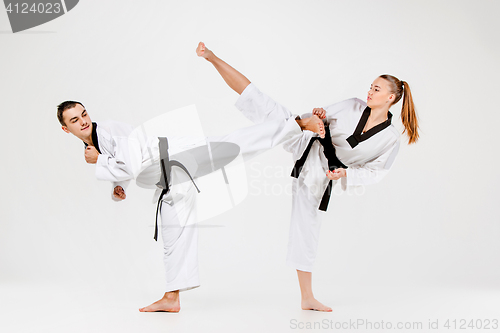 Image of The karate girl and boy with black belts