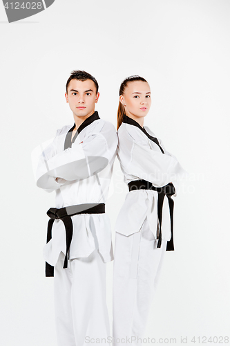 Image of The karate girl and boy with black belts