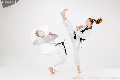 Image of The karate girl and boy with black belts