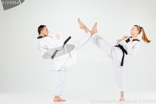 Image of The karate girl and boy with black belts