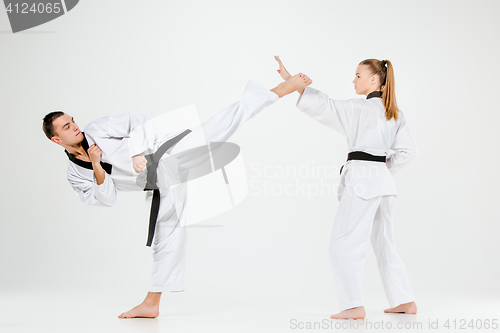 Image of The karate girl and boy with black belts