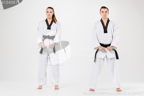 Image of The karate girl and boy with black belts