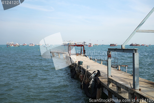 Image of Walkway to pier among blue sea and clear sky