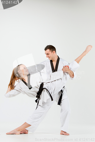 Image of The karate girl and boy with black belts