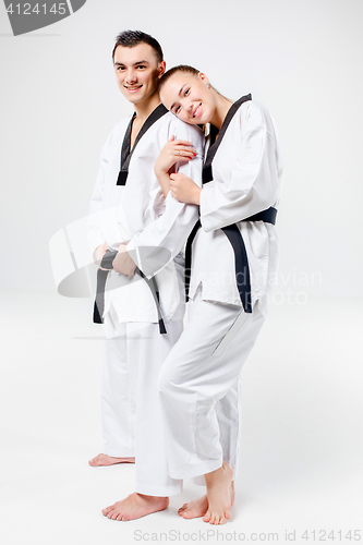 Image of The karate girl and boy with black belts