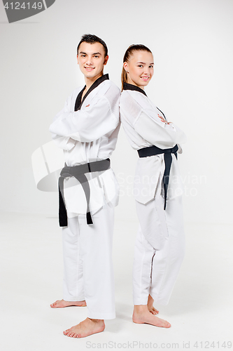 Image of The karate girl and boy with black belts