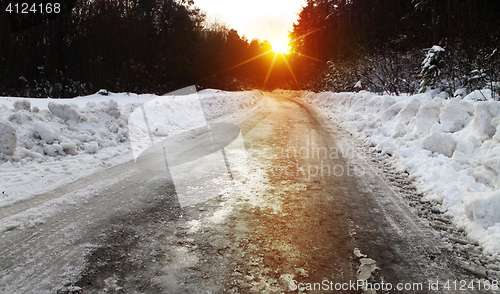 Image of winter road and forest at sunset