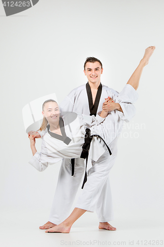 Image of The karate girl and boy with black belts