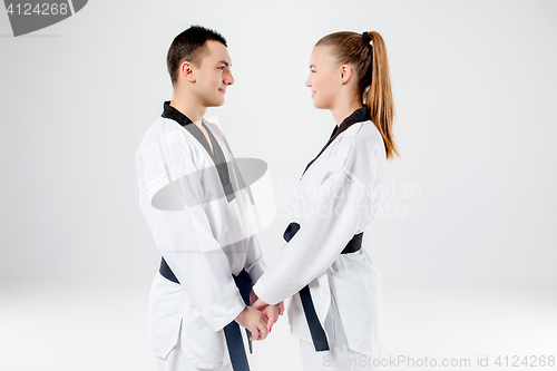 Image of The karate girl and boy with black belts