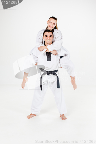 Image of The karate girl and boy with black belts