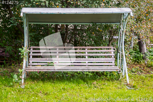 Image of Old swing bench in old apple orchard