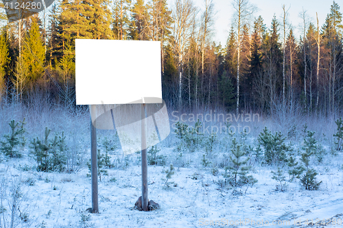 Image of Blank billboard in winter woods